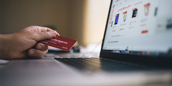 Person shopping online and holding credit card