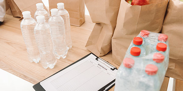 Bottles of water and groceries on counter