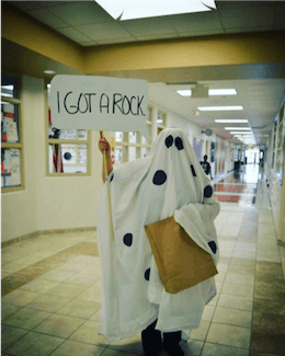 Person dressed as ghost holding I Got A Rock sign