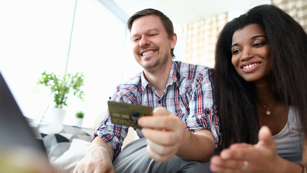 Man and woman paying bill on computer