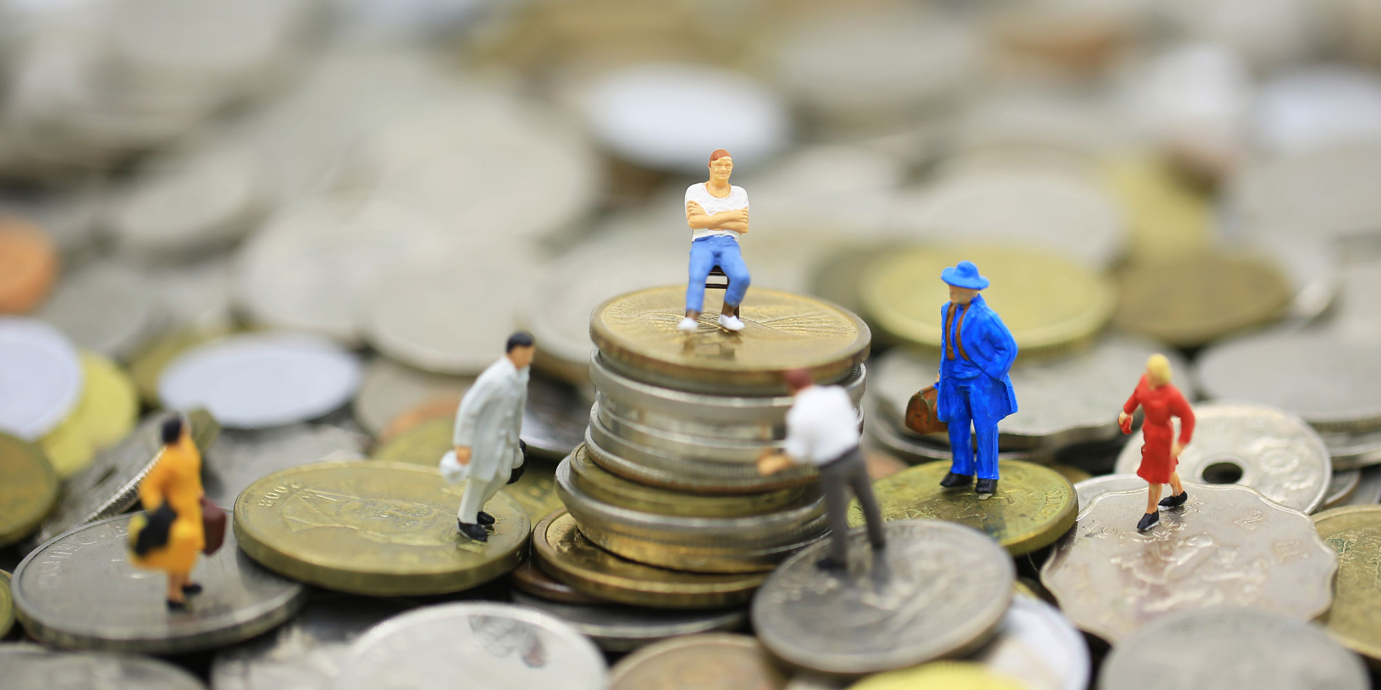 figurines on a stack of coins