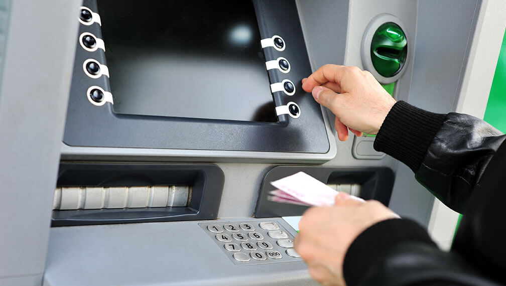 Person making deposit at ATM