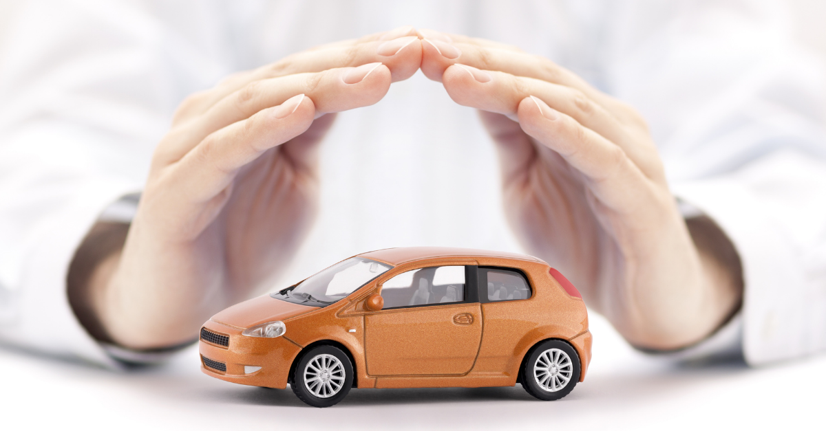 shielding a small orange car with hands