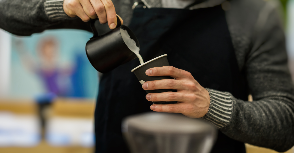 barista pouring a latte