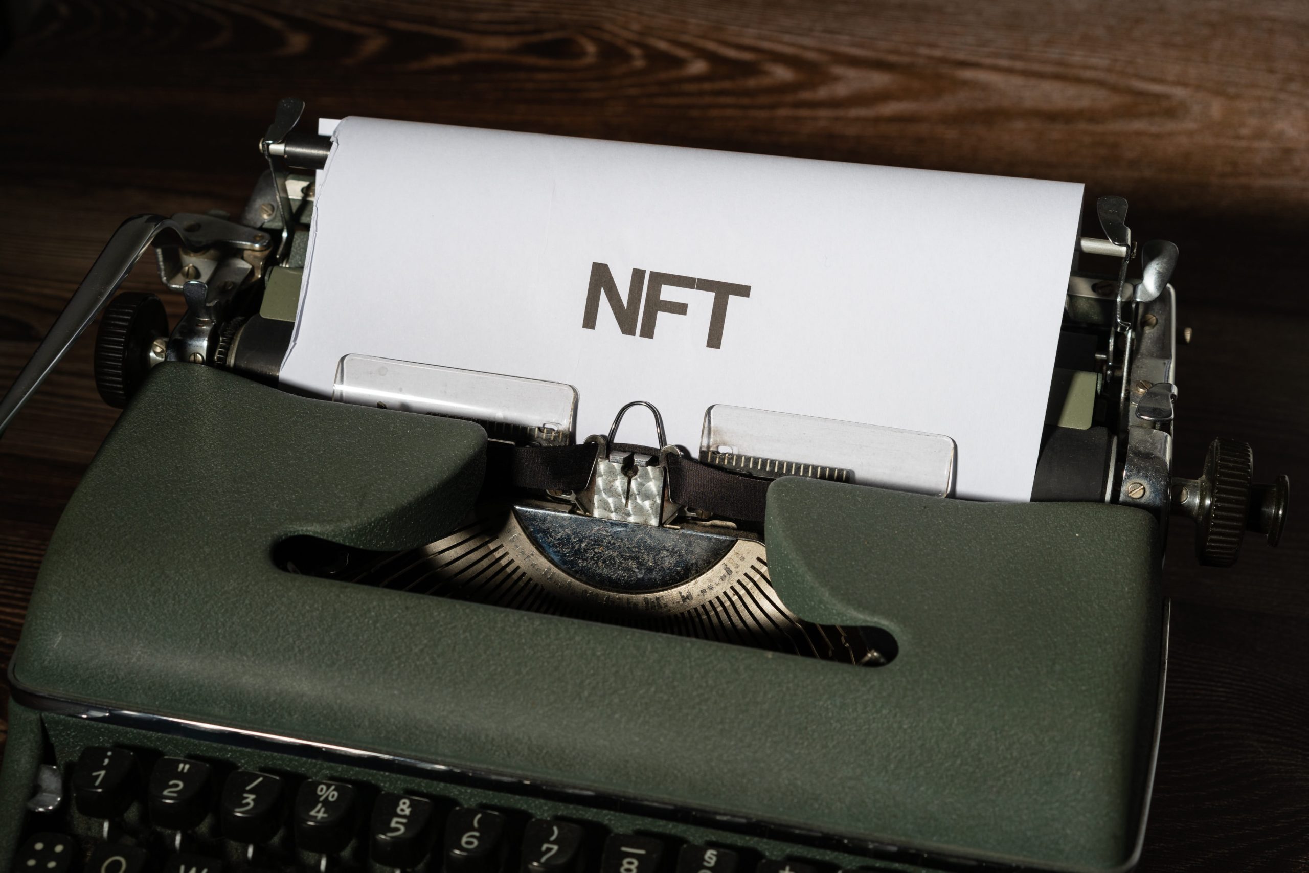 nft on a green typewriter