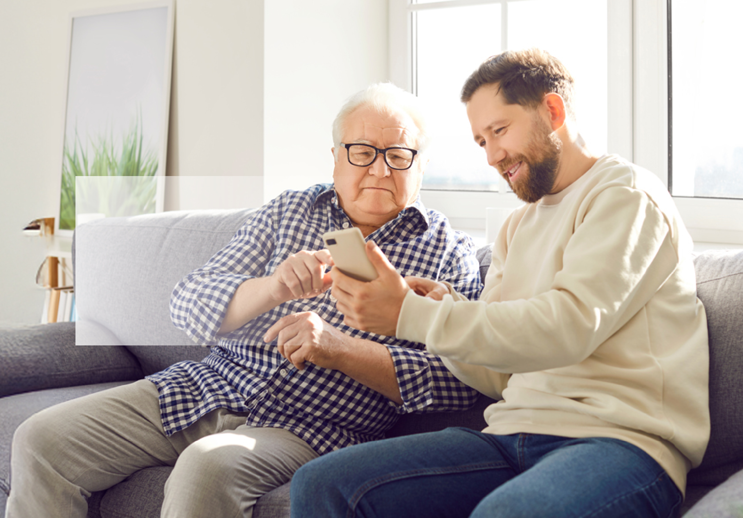 Young adult showing his phone to a Senior